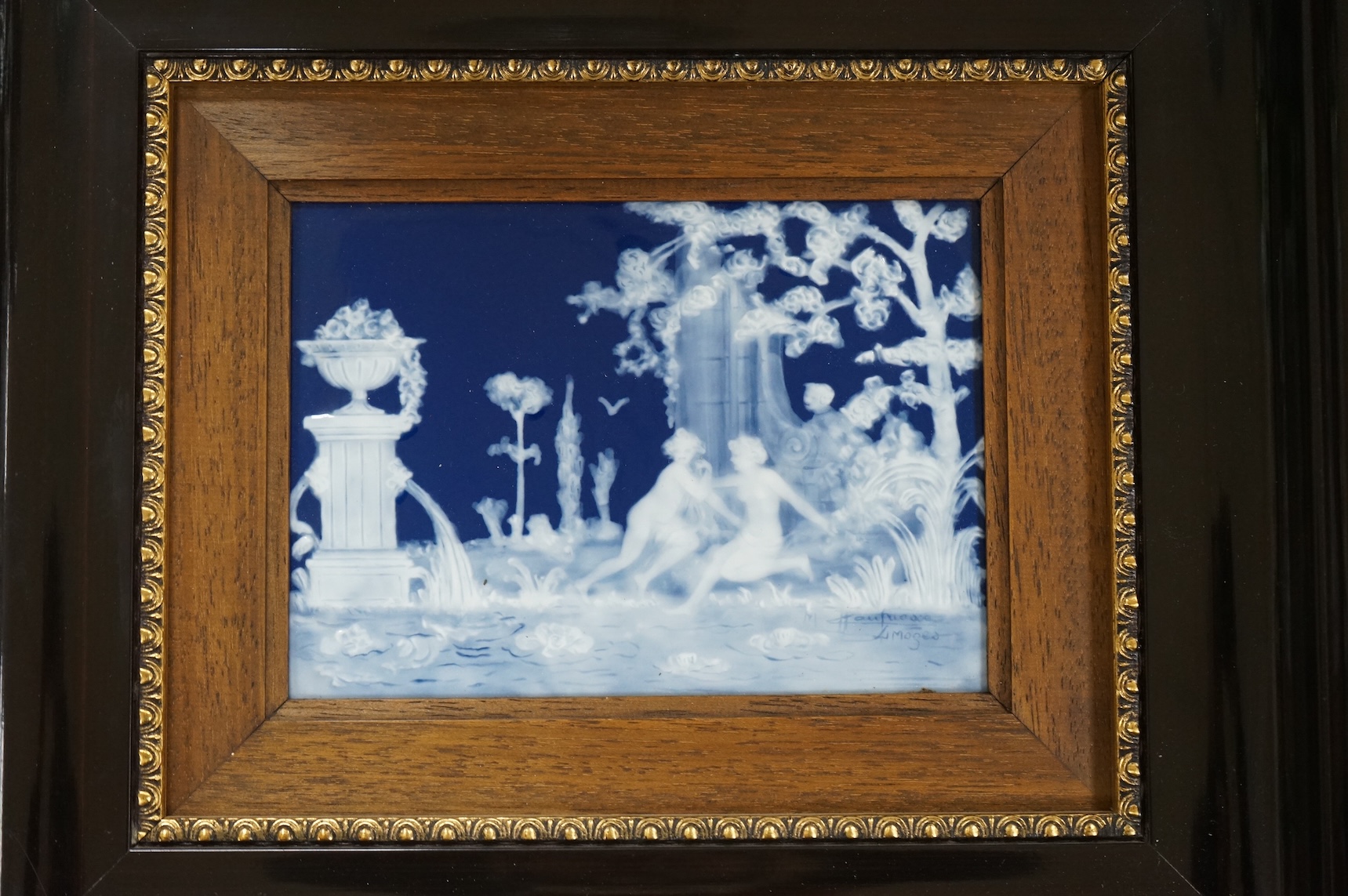 A Limoges pâte-sur-pâte panel by Marcel Chaufriasse, two figures in a classical garden, overall 29cm high